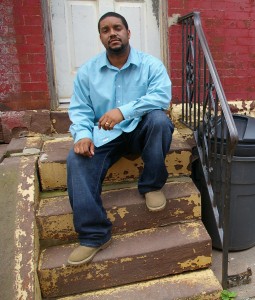 Donte sits on the stoop of his home in Strawberry Mansion.