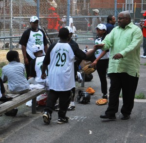 Derrick Ford greets Stawberry Mansion All-Stars before a game.